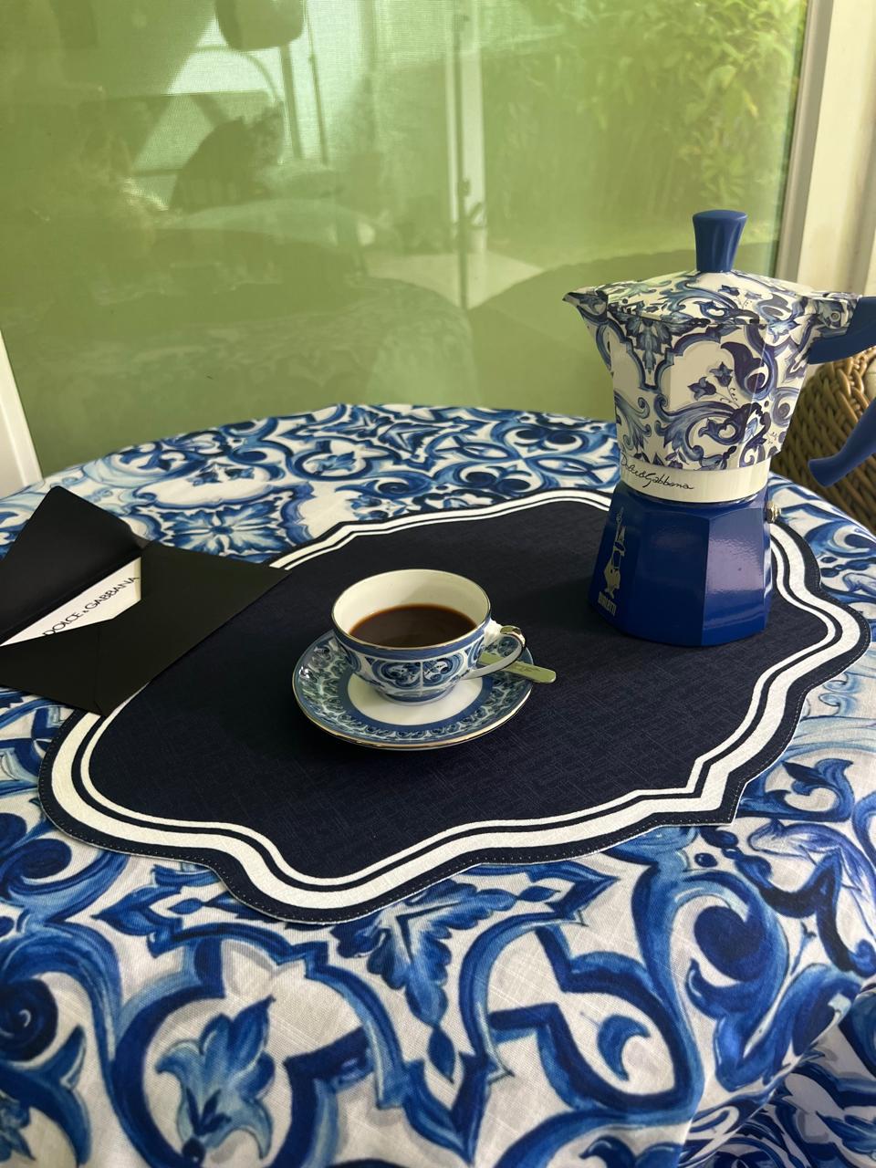 Mantel azul y blanco con individual festoneado azul marino y servicio de café